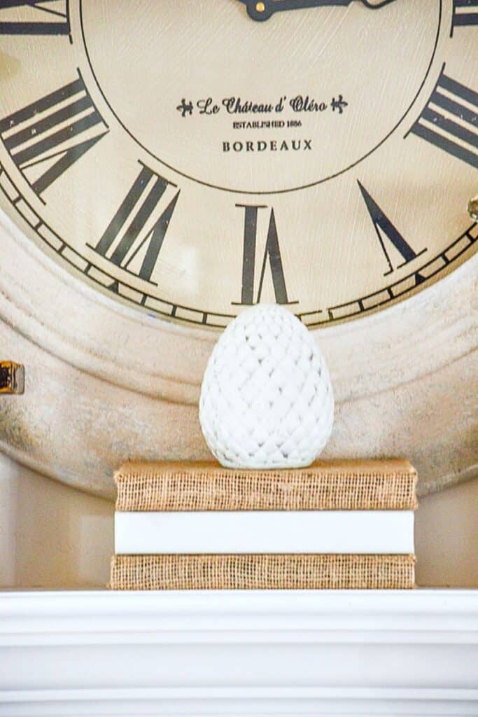 DECORATING WITH RISERS-stylized egg finial on a stack of books