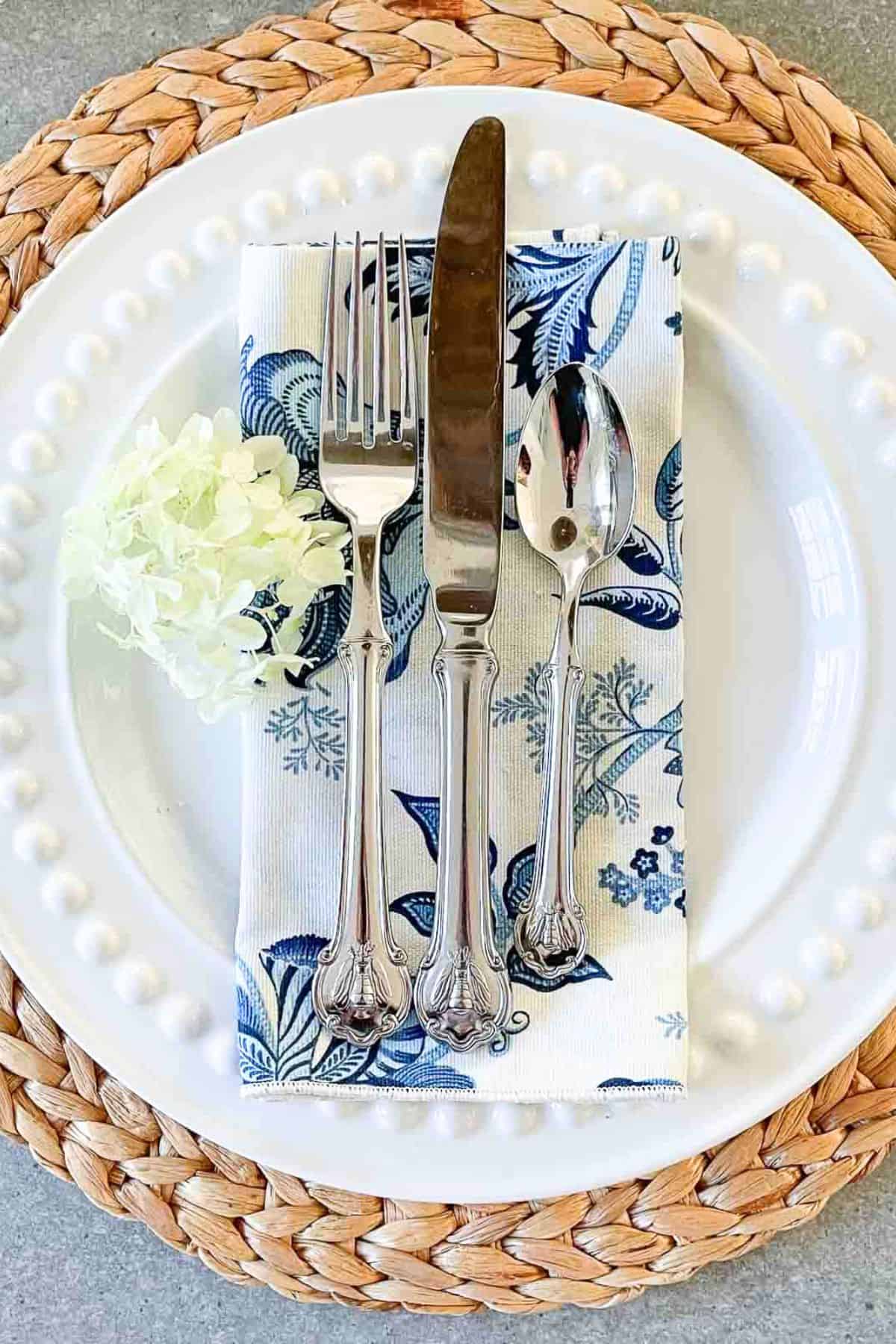 place setting with blue and white napkin