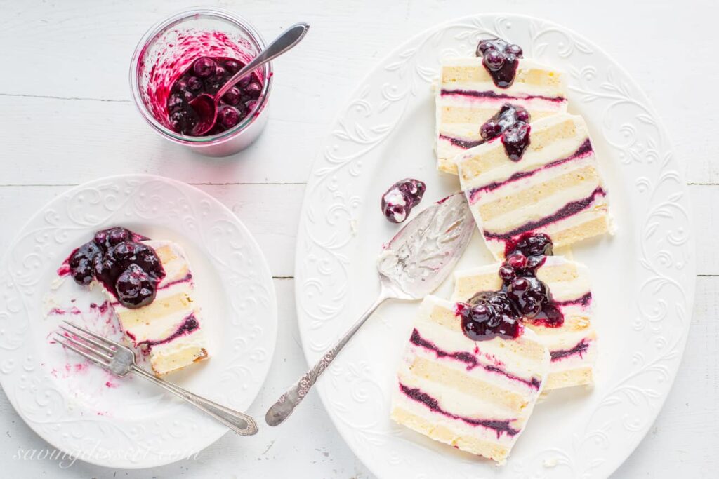slices of blueberry lemon icebox cake and a jar of blueberry sauce