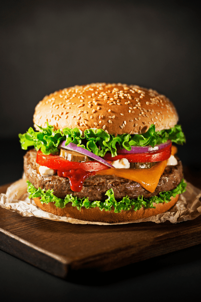 juicy hamburger with all the fixining on a sesame seed bun