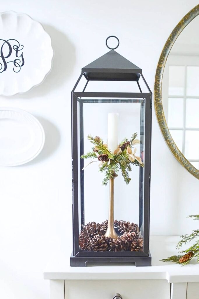 lantern with candle and pinecones