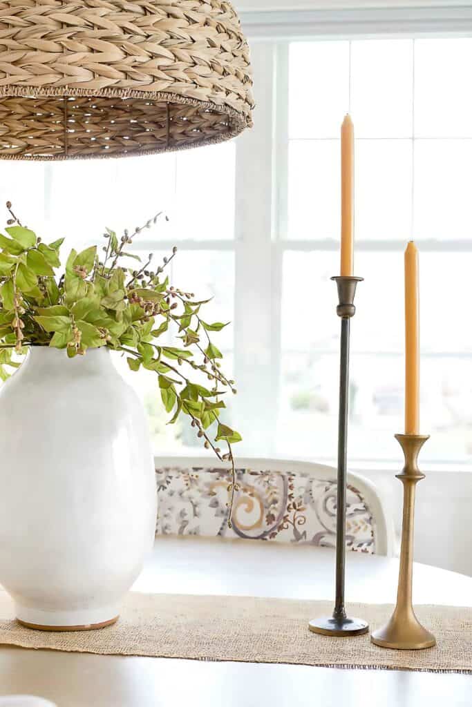 candles with a centerpiece on the dining room table