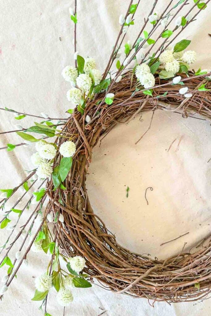 adding globe shaped flowers on the wreath