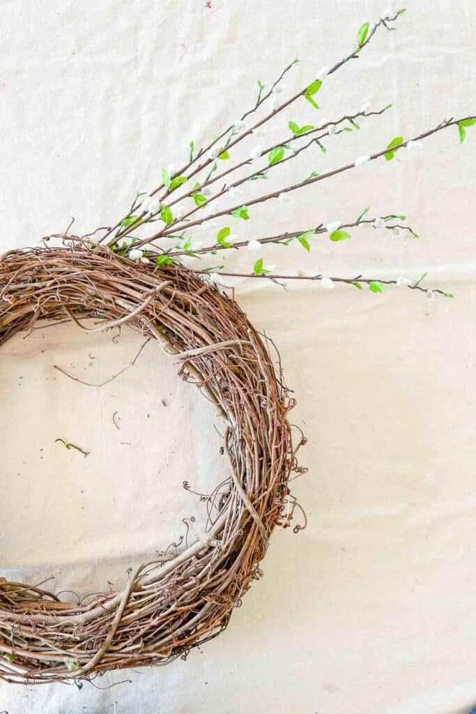 pussy willow brances on the right side of the wreath