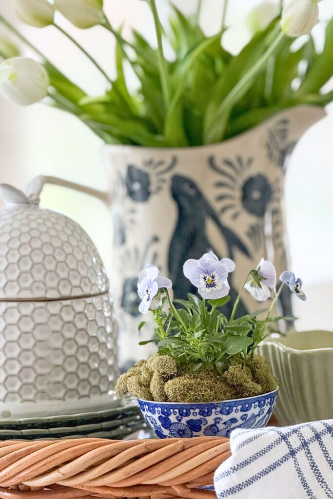 spring kitchen decorating ideas with tulips in pitcher and blue and white accessories in basket