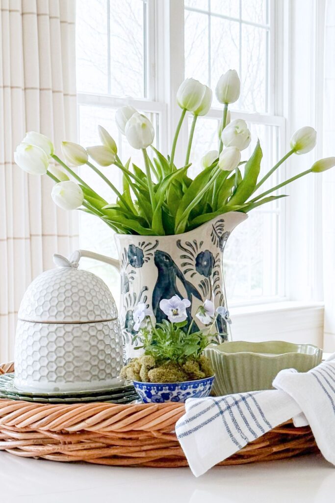spring kitchen decorating ideas with white tulips in pitcher and styled basket on island