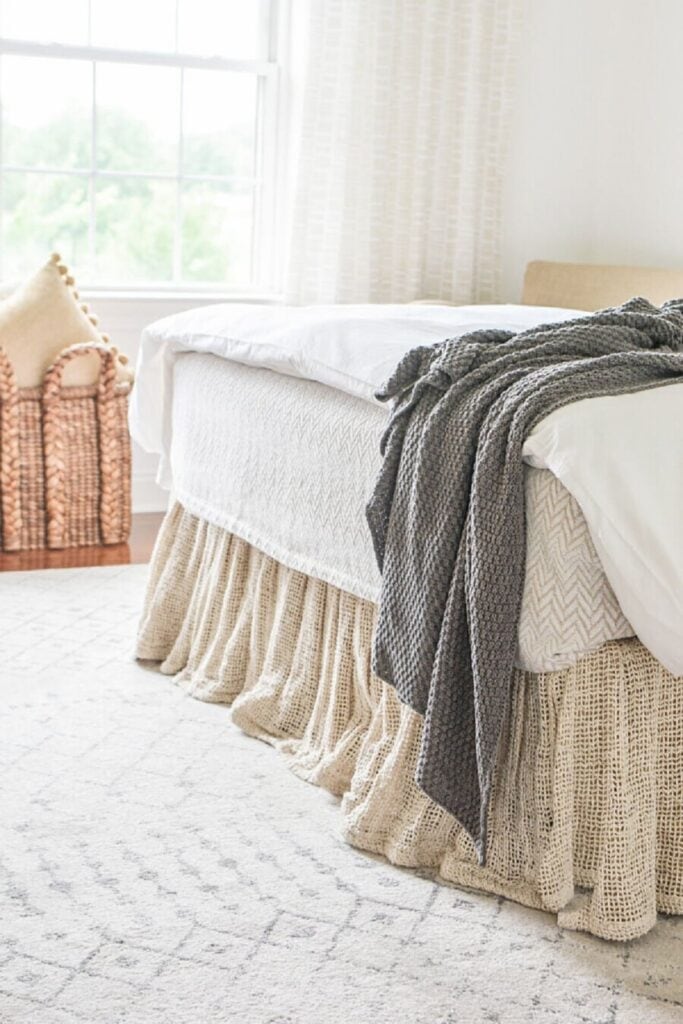 How to style a throw blanket at the end of a bed