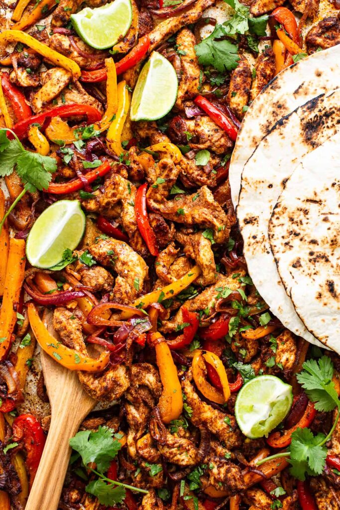 sheet pan fajitas with lines and tortillas