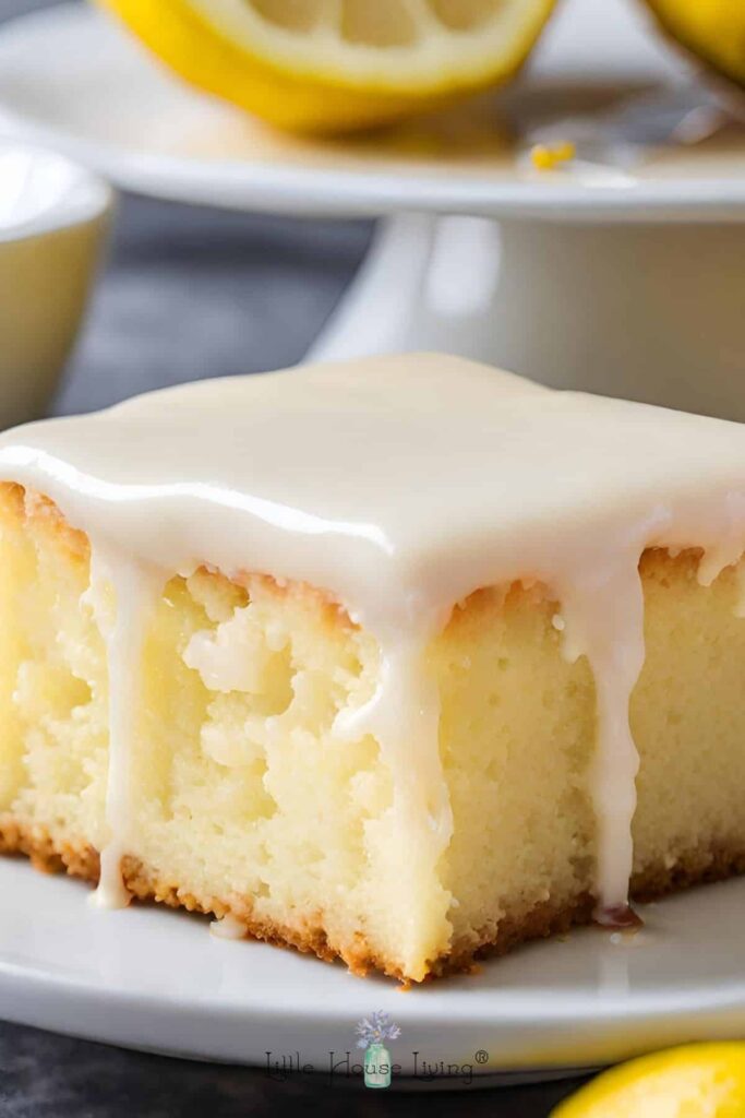 lemonade poke cake slice on a white plate