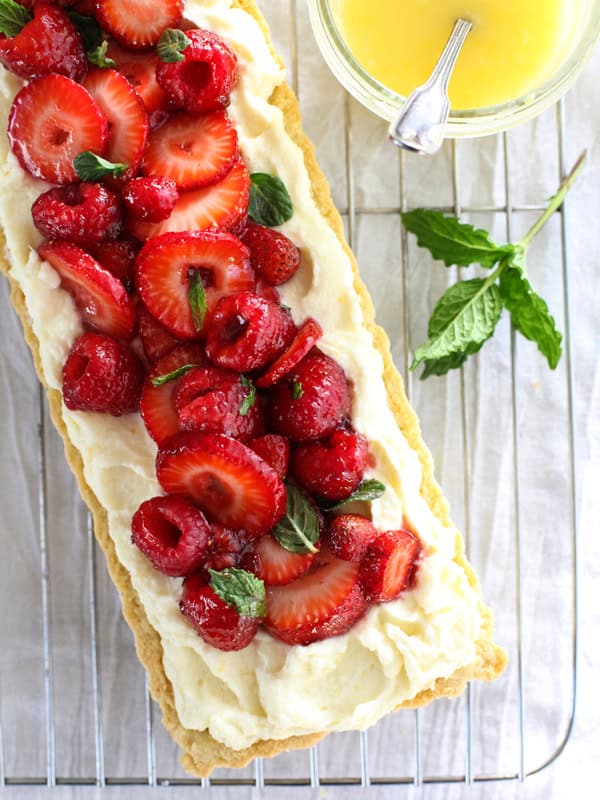 berry tart and a bowl of lemon curd