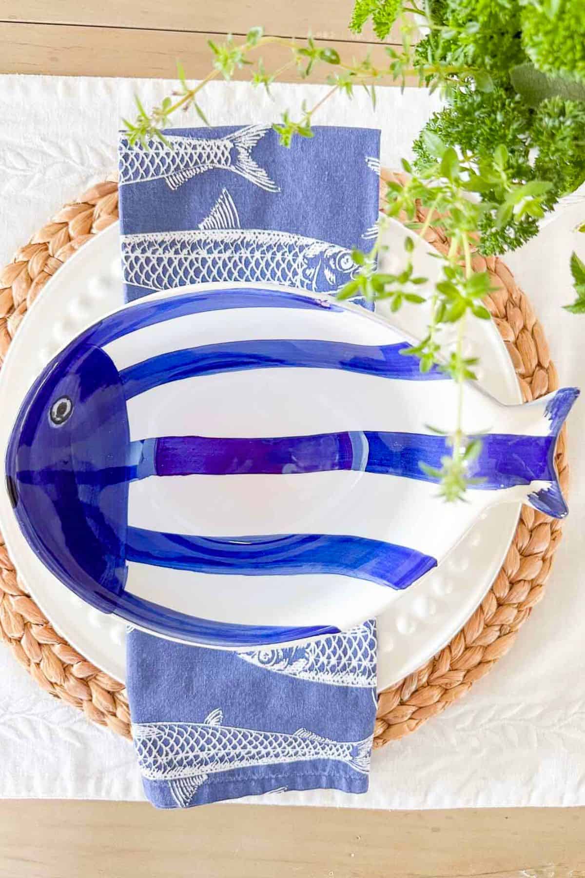 blue and white summer place setting with a bowl shaped like a fish