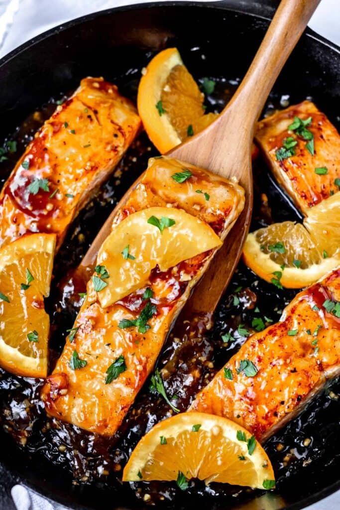 orange salmon in a cast iron skillet