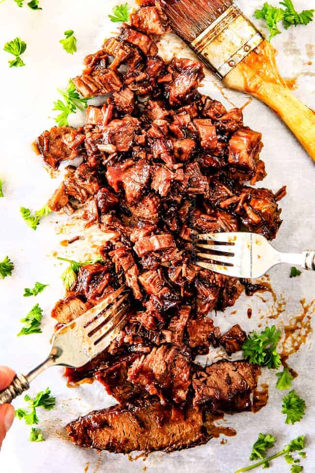 chopped beef brisket being shredded with two forks