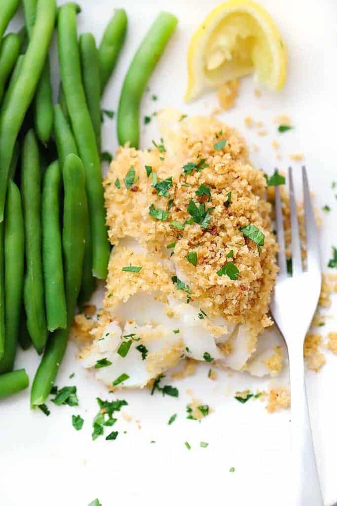 New England baked haddock on a plate with greenbean