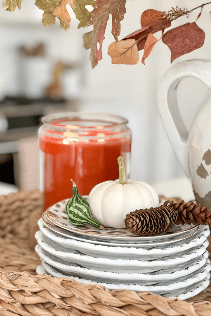white pumpkins on a stack of dishes