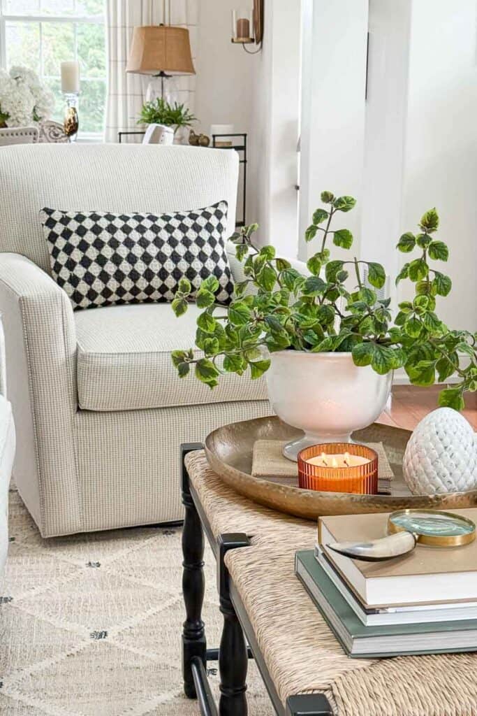 neutral swivel chair with a black and white lumbar pillow on it