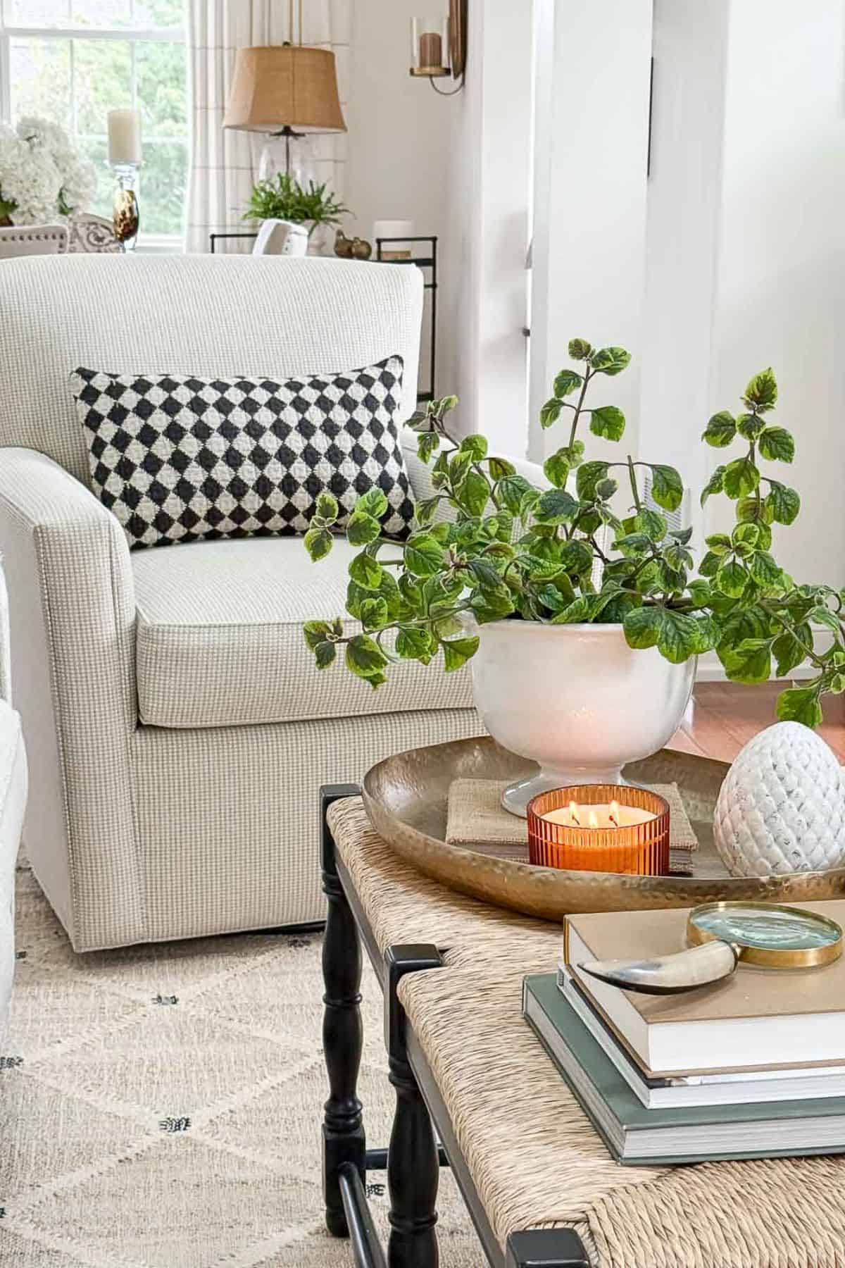 neutral swivel chair with a black and white lumbar pillow on it