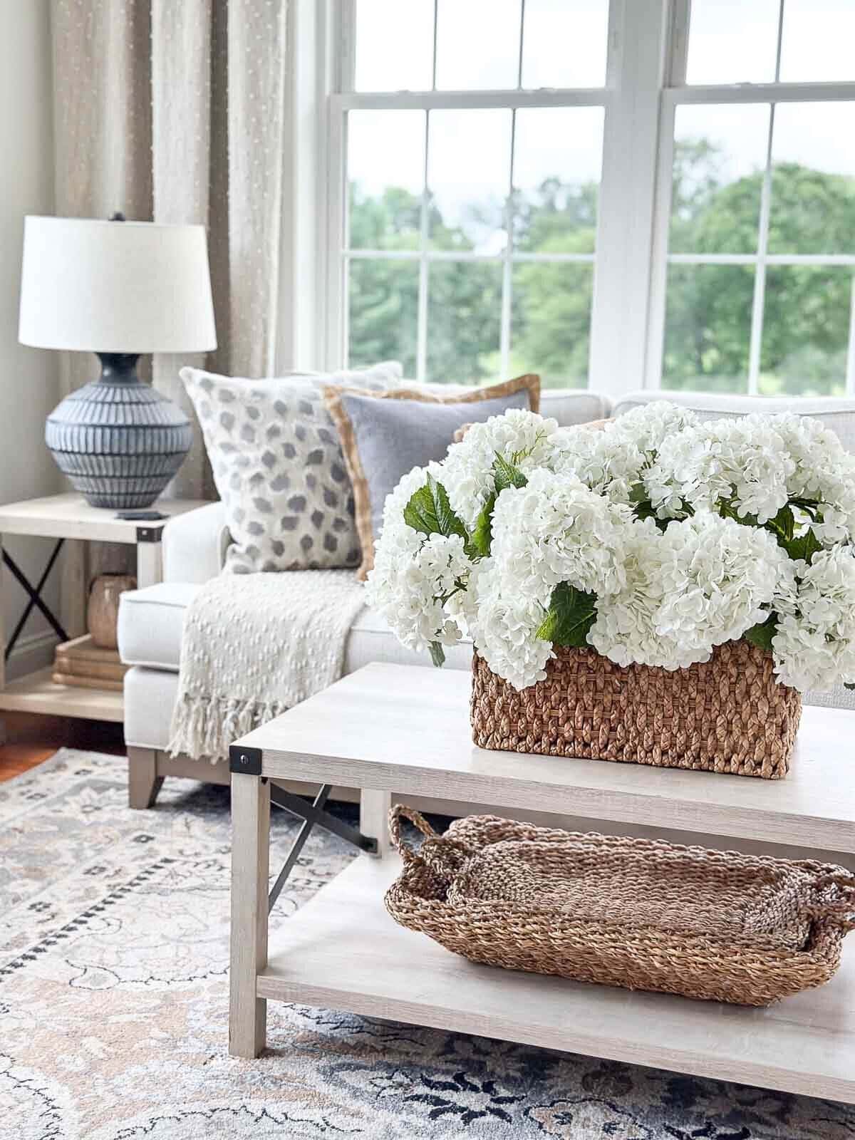 coffee table with a basket of hydrangeas