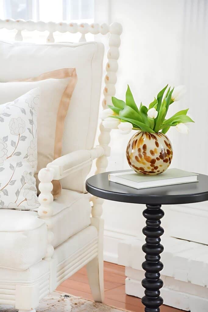 drink table with a vase of tulips on it