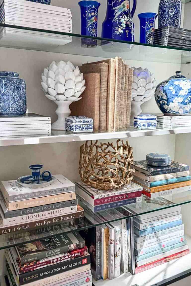 curio cabinet decorating with books and blue and white decor