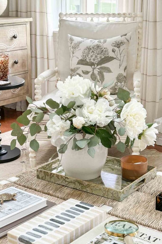 peonies in a tray on a coffee table