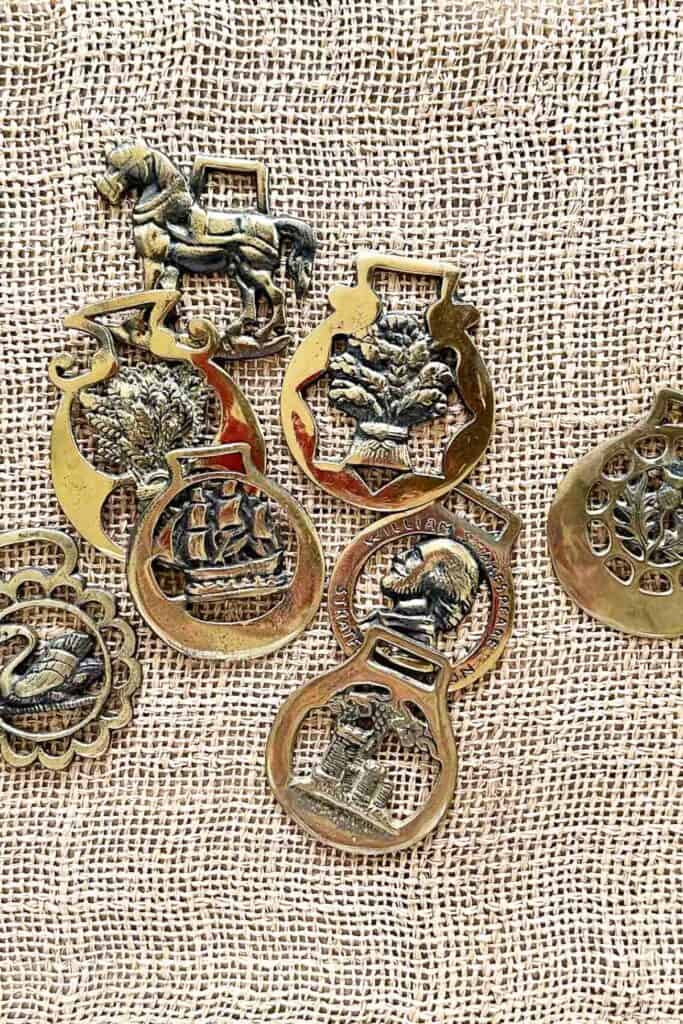 1- STORIED HOME: antique horse brass on burlap