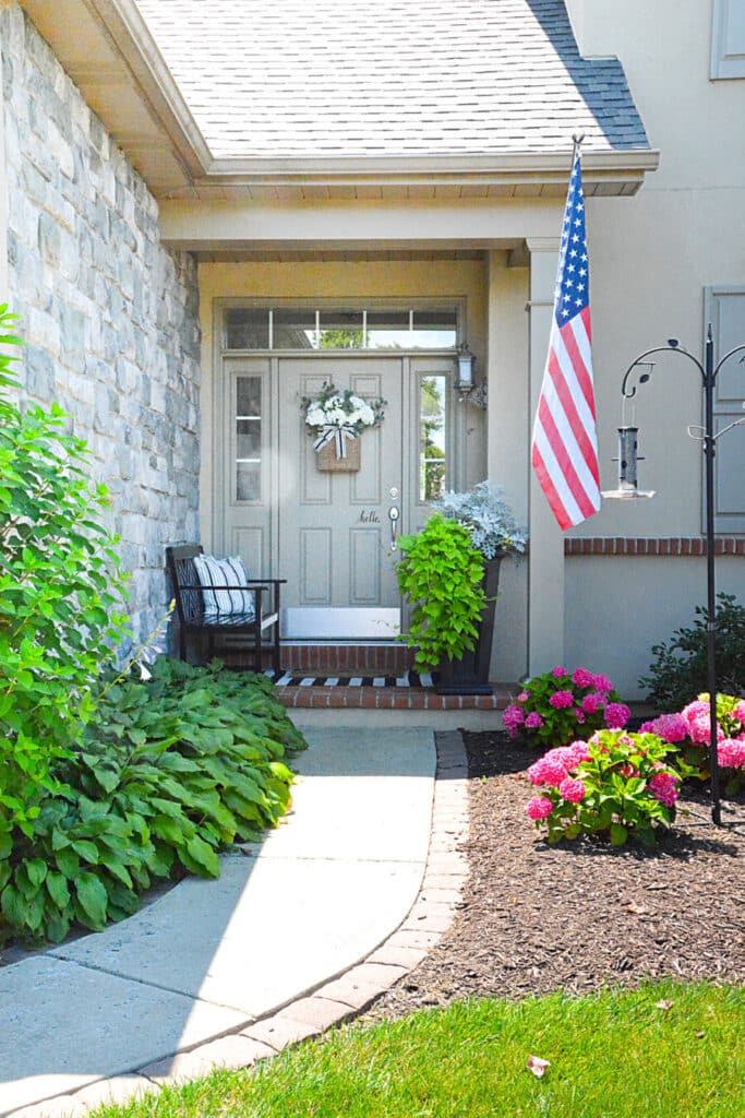 HOME WITH AN AMERICAN FLAG IN FRONT OF IT