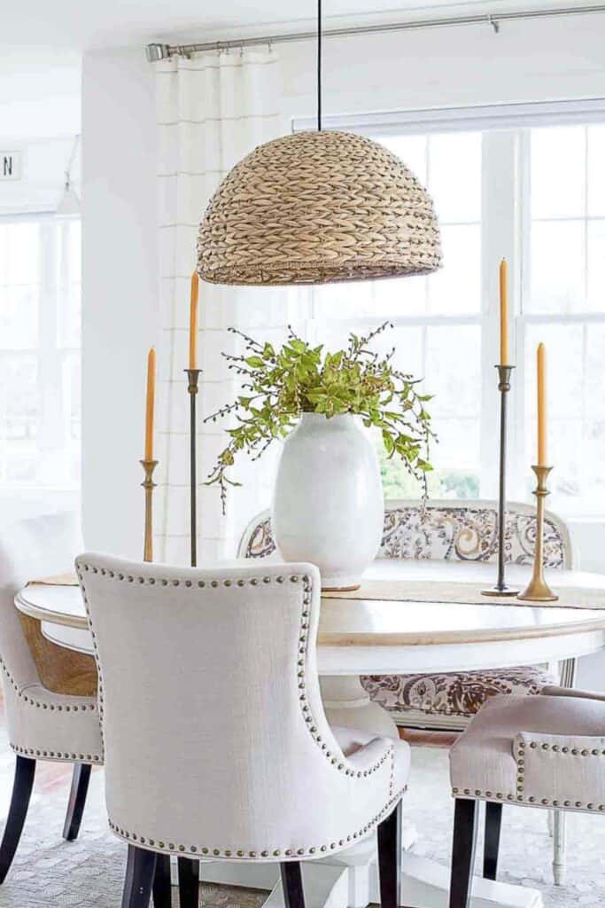 dining room with urn full of greens on the table