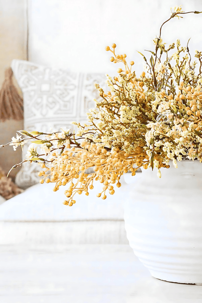 Easy fall arrangement made with dried florals and faux berries in a vase