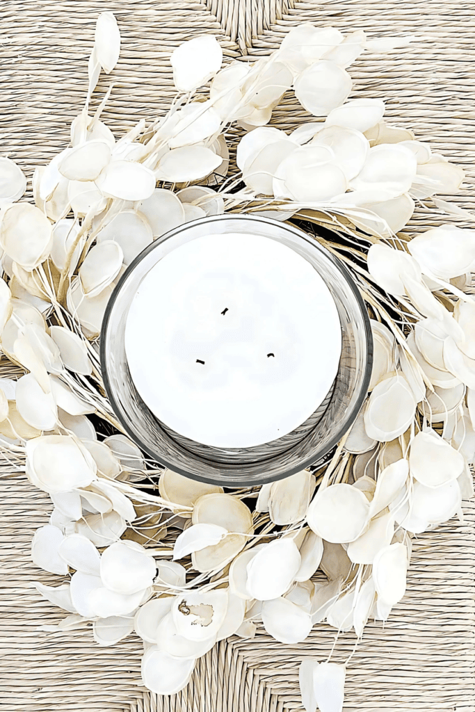 Fall wreath used as a candle ring centerpiece with hurricane glass and candle