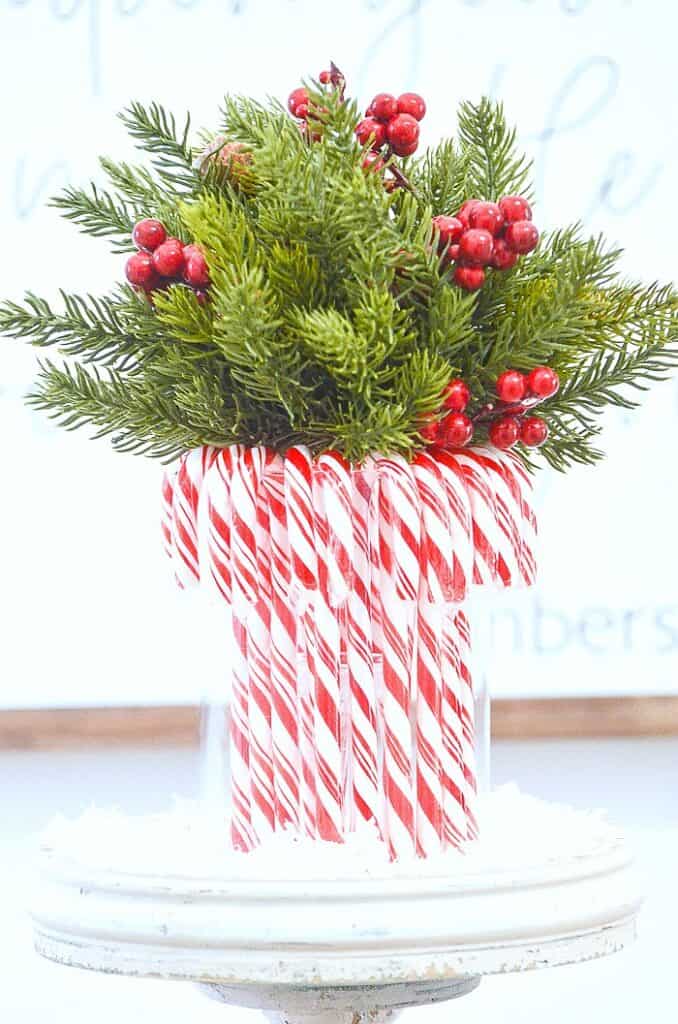Candy canes holding up Christmas greens