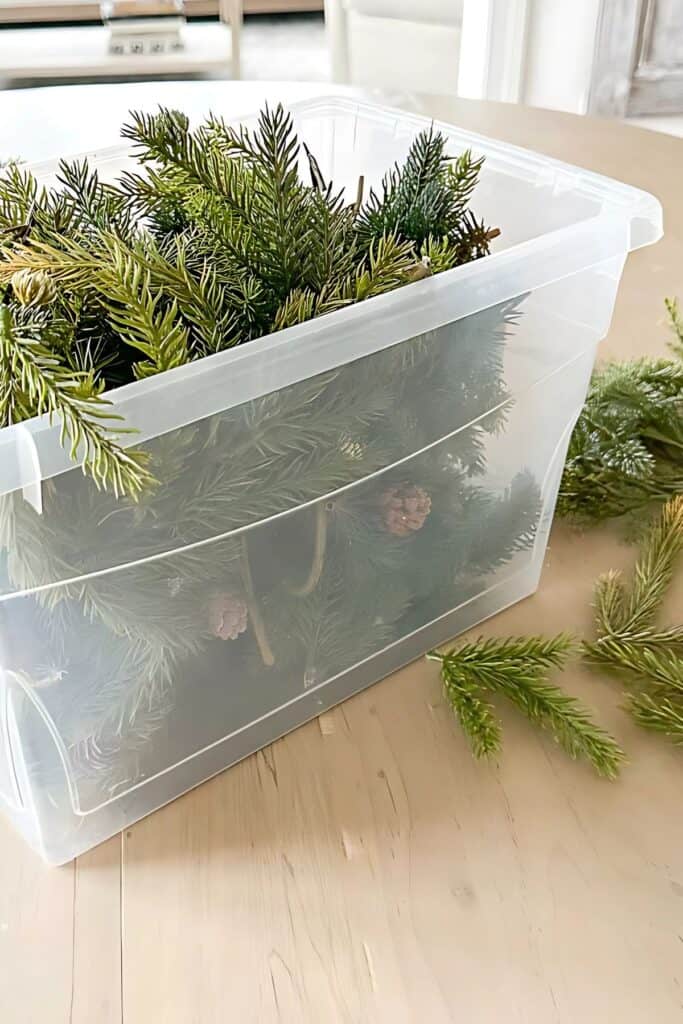 how to store faux Christmas greens in a clear plastic bin to keep them fresh for next year