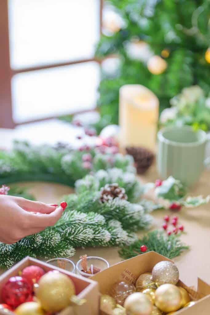 woman with red fingernails making a weath