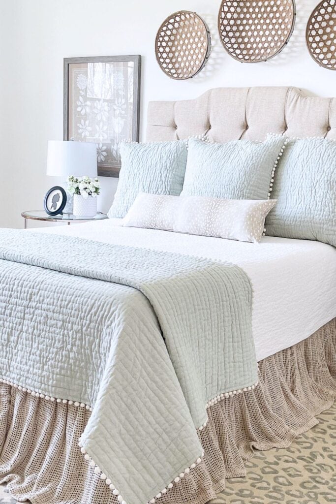wall baskets arranged above bed adding texture and natural style to a bedroom