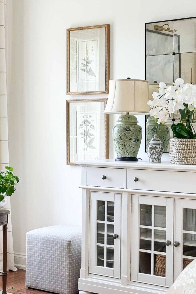 end of whit buffet with white wall with botanicals