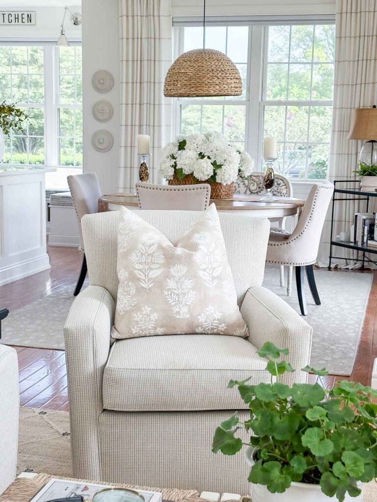 neutral living room looking into a relaxed neutral dining room