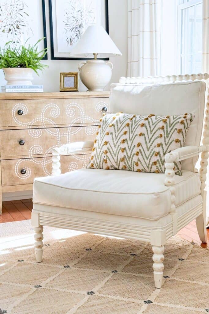 vintage pillow on a white spindle chair in the living room