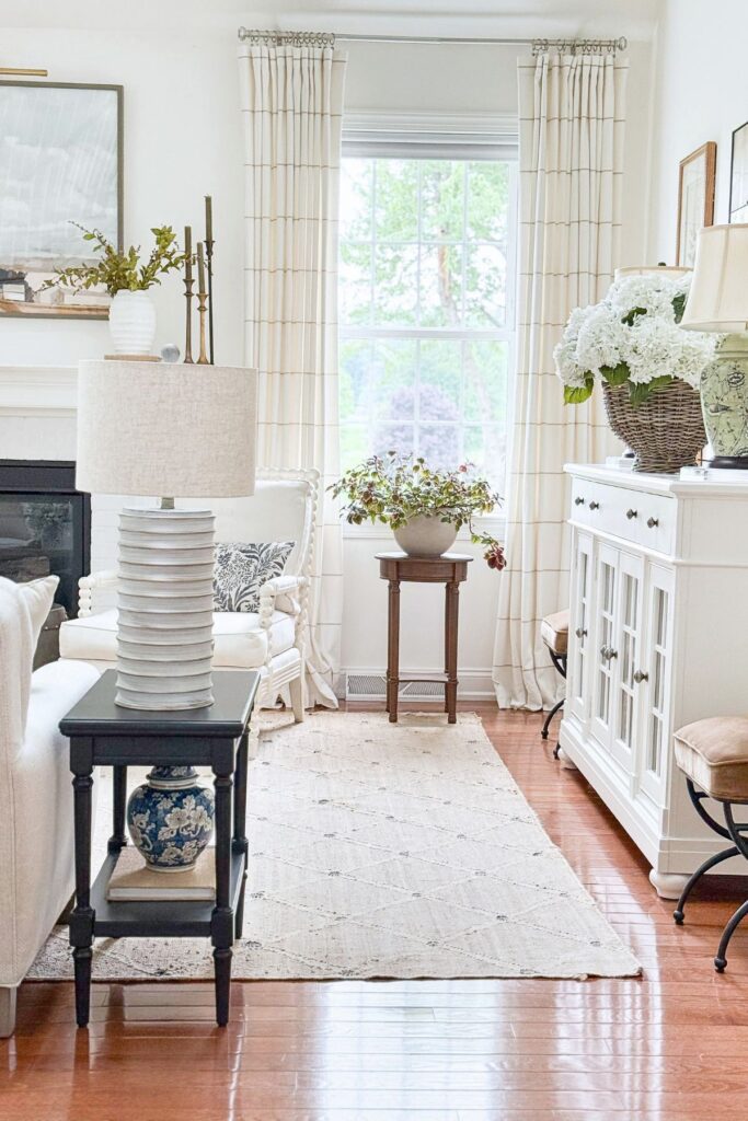 Tanglewood House living room with Benjamin Moore Simply White walls, warm beige accents, and blue and white decor