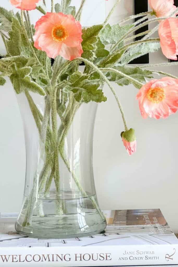 WATER IN A GLASS VASE WITH FAUX FLOWERS