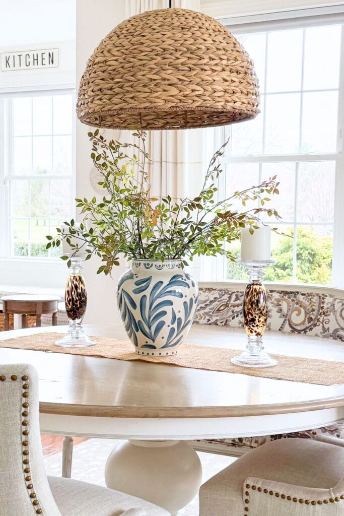 blue and white vase with greenery styled on a flat surface for simple after Easter decorating