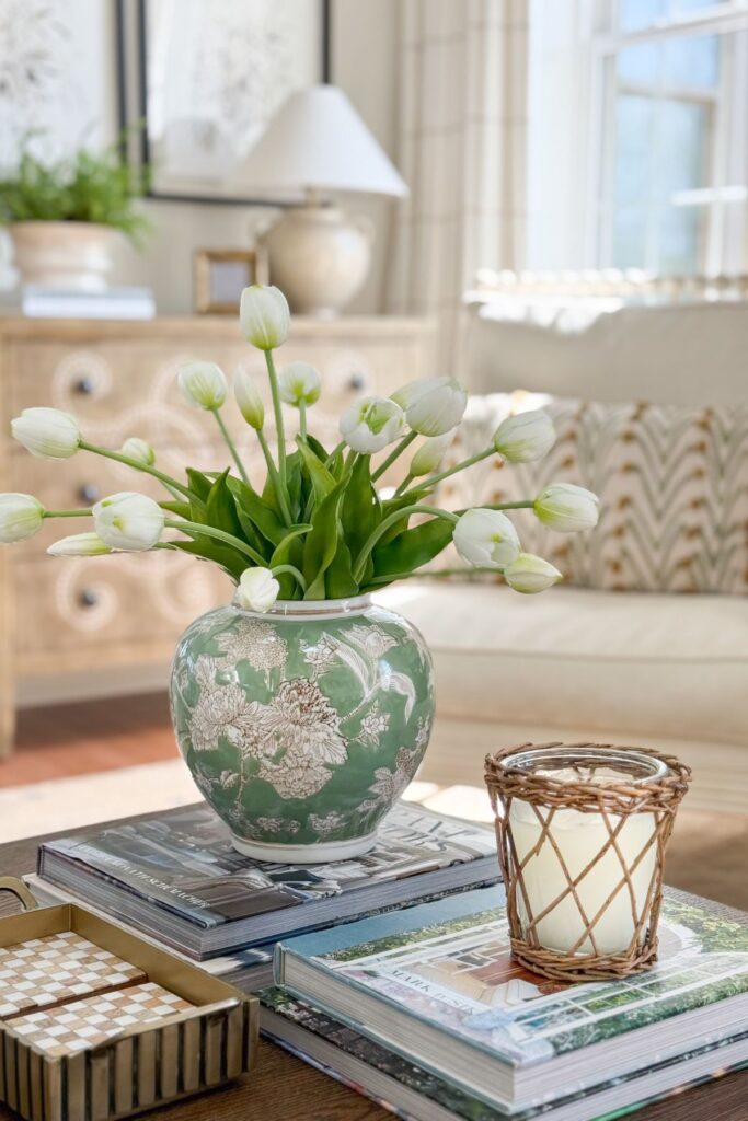 White tulips in a green patterned vase on the coffee table for a fresh and easy after Easter decoration