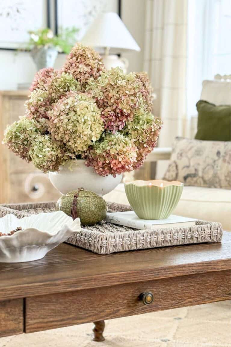 drying hydrangeas in a white urn on a coffee table