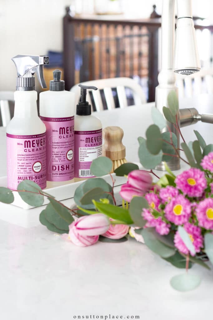 Mrs Myer cleaning products near a kitchen sink + flowers