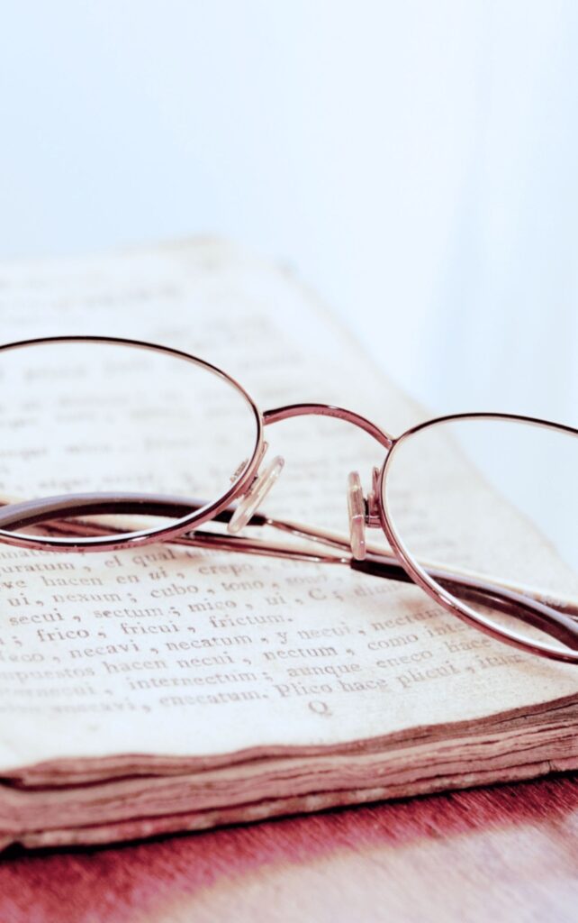 women's glasses on a bible