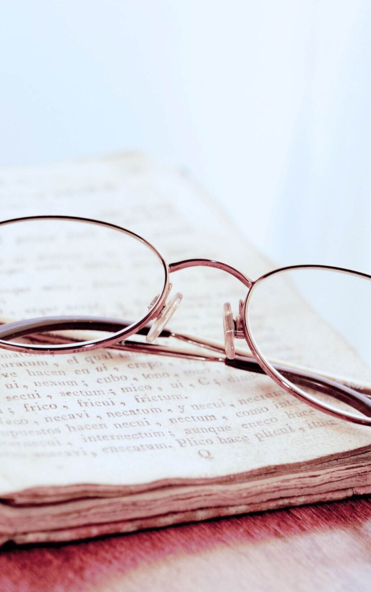 women's glasses on a bible