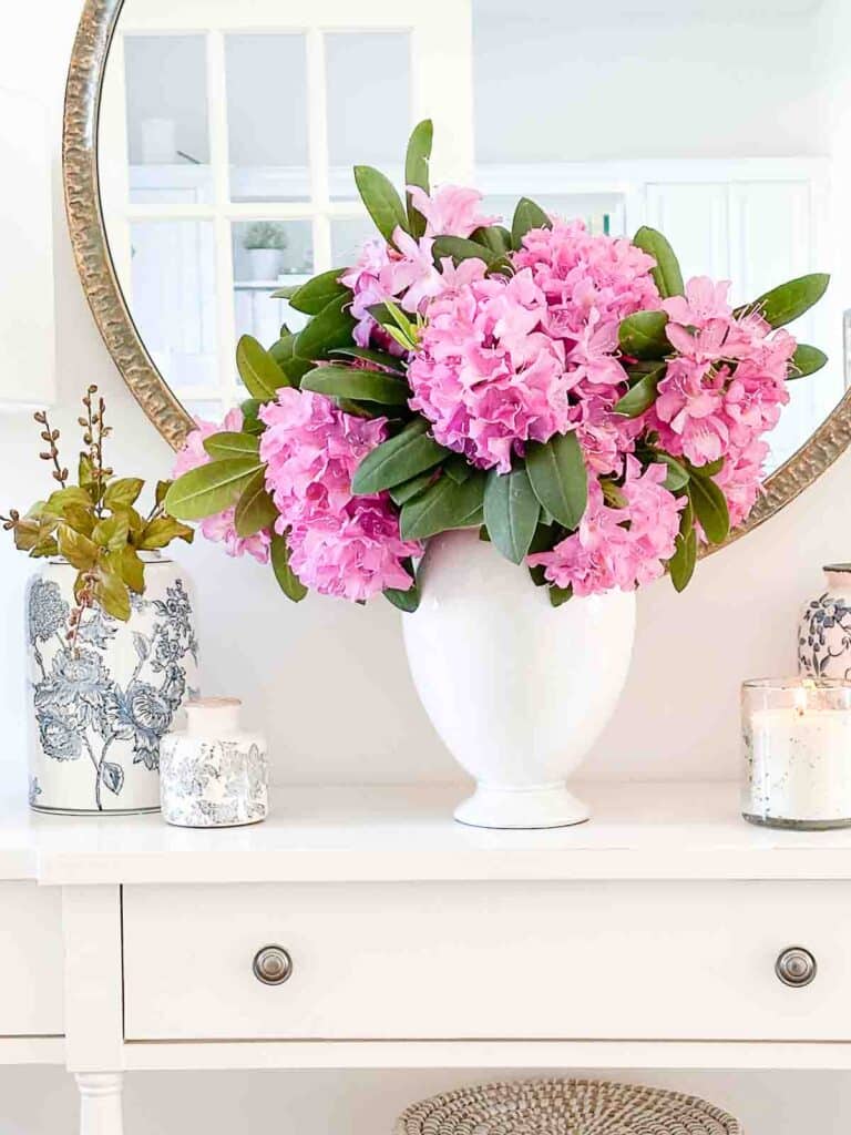 rhododendron in a white vase on a foyer table