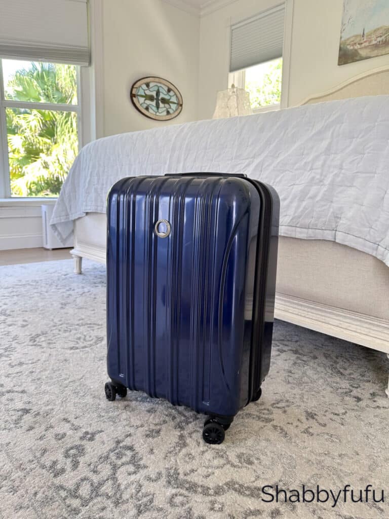 blue carry on bag in a bedroom