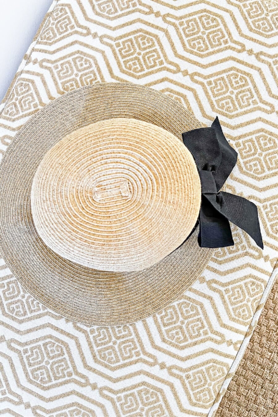summer hat on an upholstered bench