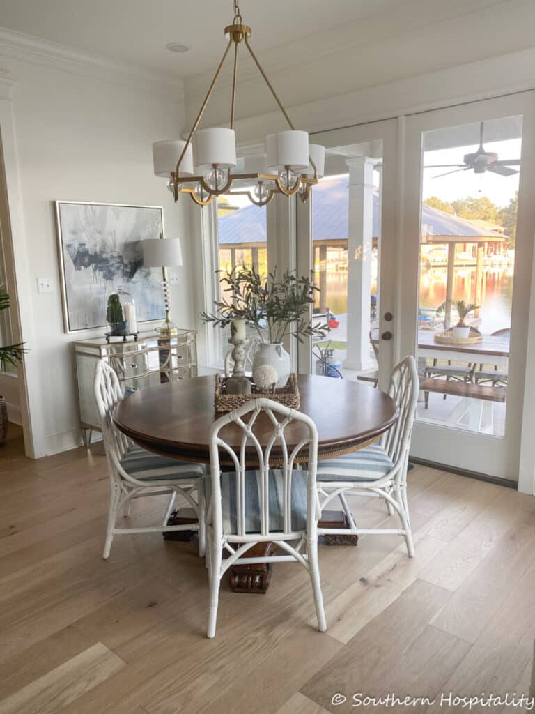 a dining room with white wicker chairs