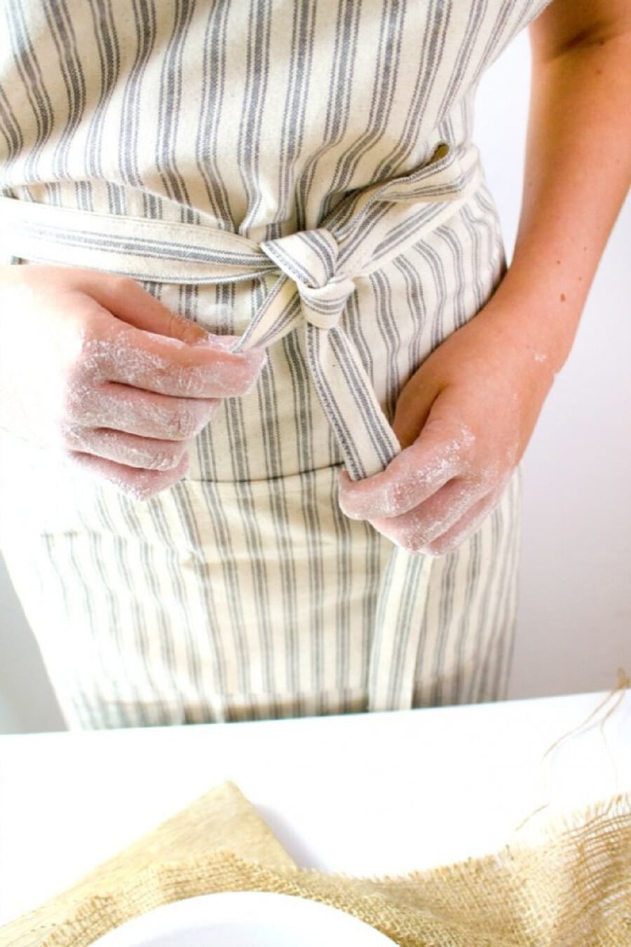 a woman with an apron on baking